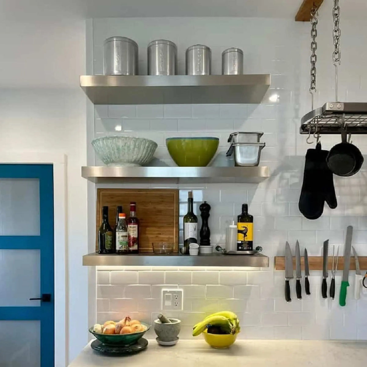 Brushed stainless steel floating shelf perfectly fits above Wolf stove or range. Ideal for spice jars or decor, combining durability with a sleek modern look. Heat-resistant, easy to clean, and handmade for professional-grade kitchens.