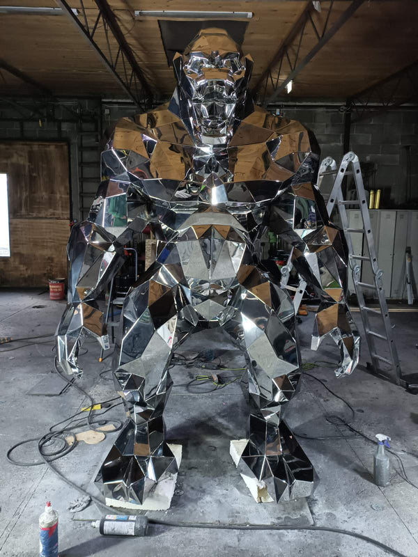 Large metallic sculpture in a workshop setting