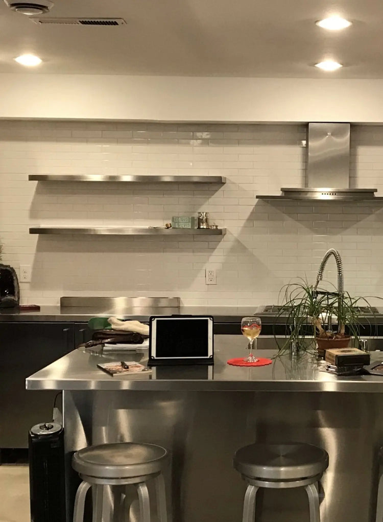 Modern kitchen with stainless steel appliances and a bar area.