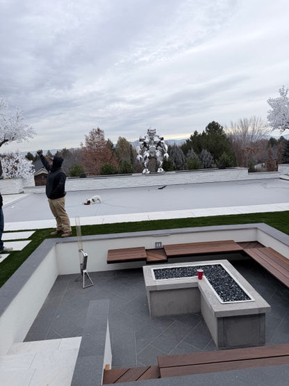 Gorilla sculpture at the Outdoor patio area with a fire pit and seating on a cloudy day. 