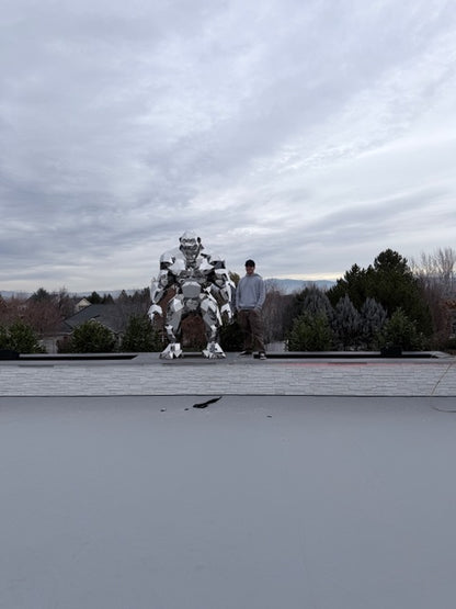 Futuristic cityscape with a tall sculpture of Gorillas and a large cloud-like structure.