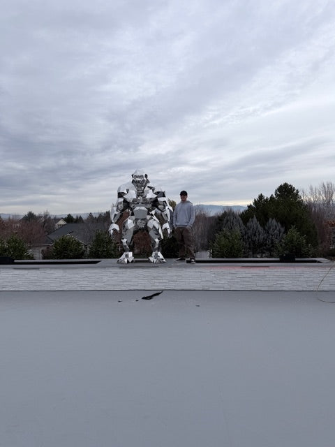 Futuristic cityscape with a tall sculpture of Gorillas and a large cloud-like structure.
