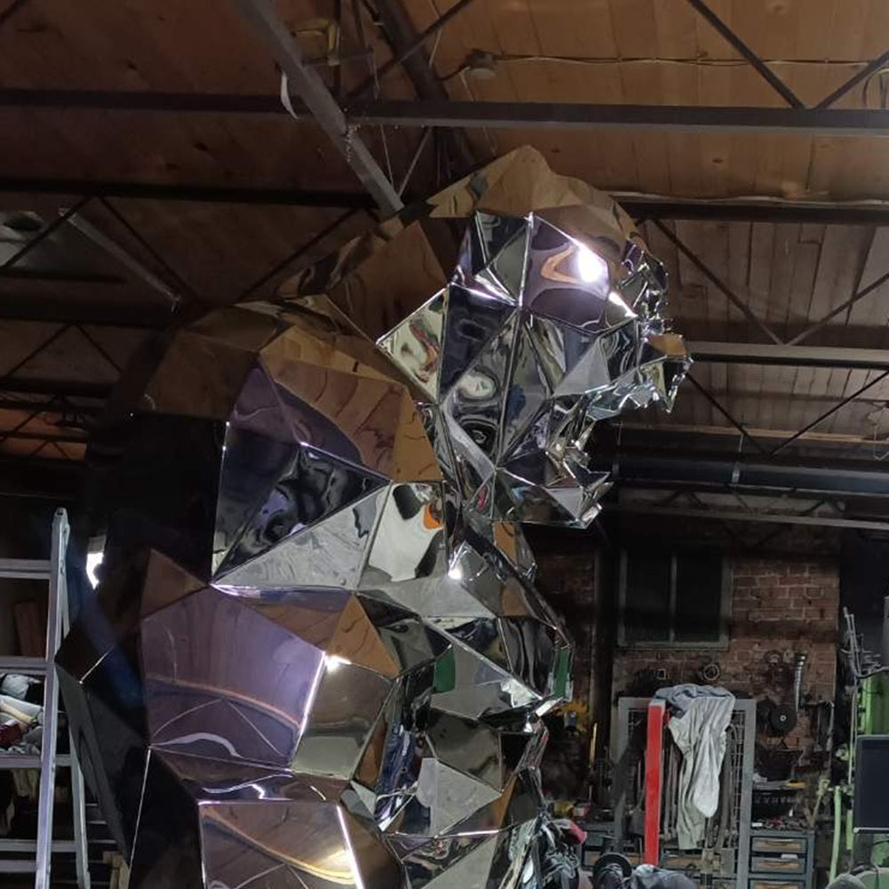 Large metallic sculpture in a workshop setting