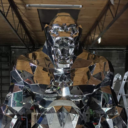 Large metallic sculpture of a Gorilla in an industrial setting