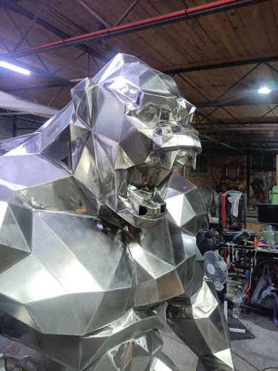 Geometric sculpture of a lion head in a workshop setting
